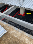 Vapor barrier with sealed joints under garage structural floor