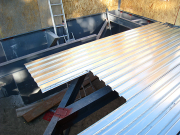 Steel Beams are Sheathed with Corrugated Metal Sheeting