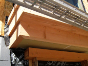 Living room window shelf wrapped with timber beams