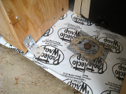 Vent hole with screen on bottom of battered framing