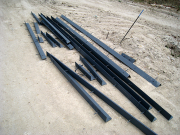 Steel angles for concrete curb under battered walls