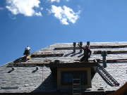 Roofers finishing last portion of roof
