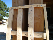 Battered post framing is bolted per plan