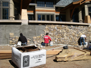 Stone crew working on south patio battered wall