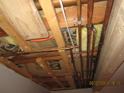 A lot of existing pipes above new closet