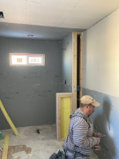 Carlos installing drywall in master bath