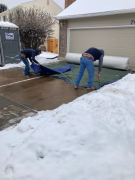 Putting down tarp to protect carpet when being cut