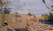 Roof truss being lowered into position