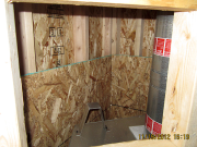 OSB behind fireplace open for insulation