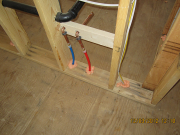 Wire and pipe openings are foamed for air infiltration control