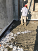 Placing concrete for basement floor