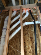 Main plumbing stacks exiting house in bedroom #1 closet