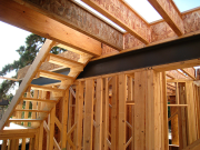 Steel beam inside interior wall by stairs