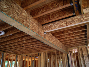 Steel beam in garage wrapped for drywall