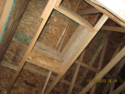 attic access is framed with an insulation retaining barrier