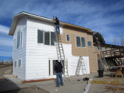 painters priming new siding