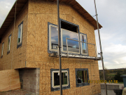 large & high windows are installed from scaffold