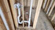 Studio laundry drain and vent line plumbing