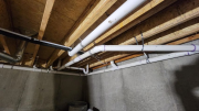 Plumbing drain pipes in crawlspace below studio bathroomÂ