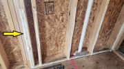 Caulking in progress to tighten up stud spacing behind tub deck