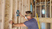 Pavel is shaving studs with planer for straight walls