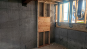 Wall to receive electrical panels in basement
