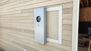 Electric meter housing outside of garage