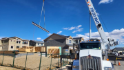 Crane placing garage steel beam