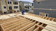 Bob applying glue for third floor subfloor