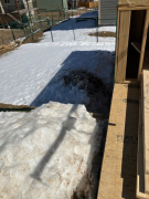 Snow piles behind studio walls