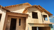 Front of house with front porch roof framed