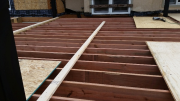Deck joists are braced to stay straight