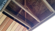 Insect screen behind roof soffits