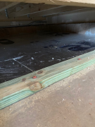Ridged insulation in place on floor before fiberglass blown insulation