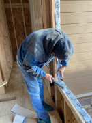 Paul installing tape flashing prior to window installation