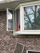 Bay window with plastic vent hole during asbestos mitigation
